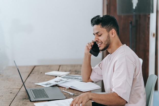 Photo of worker sitting at desk on the phone