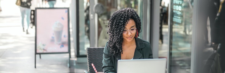photo of young business woman working on computer